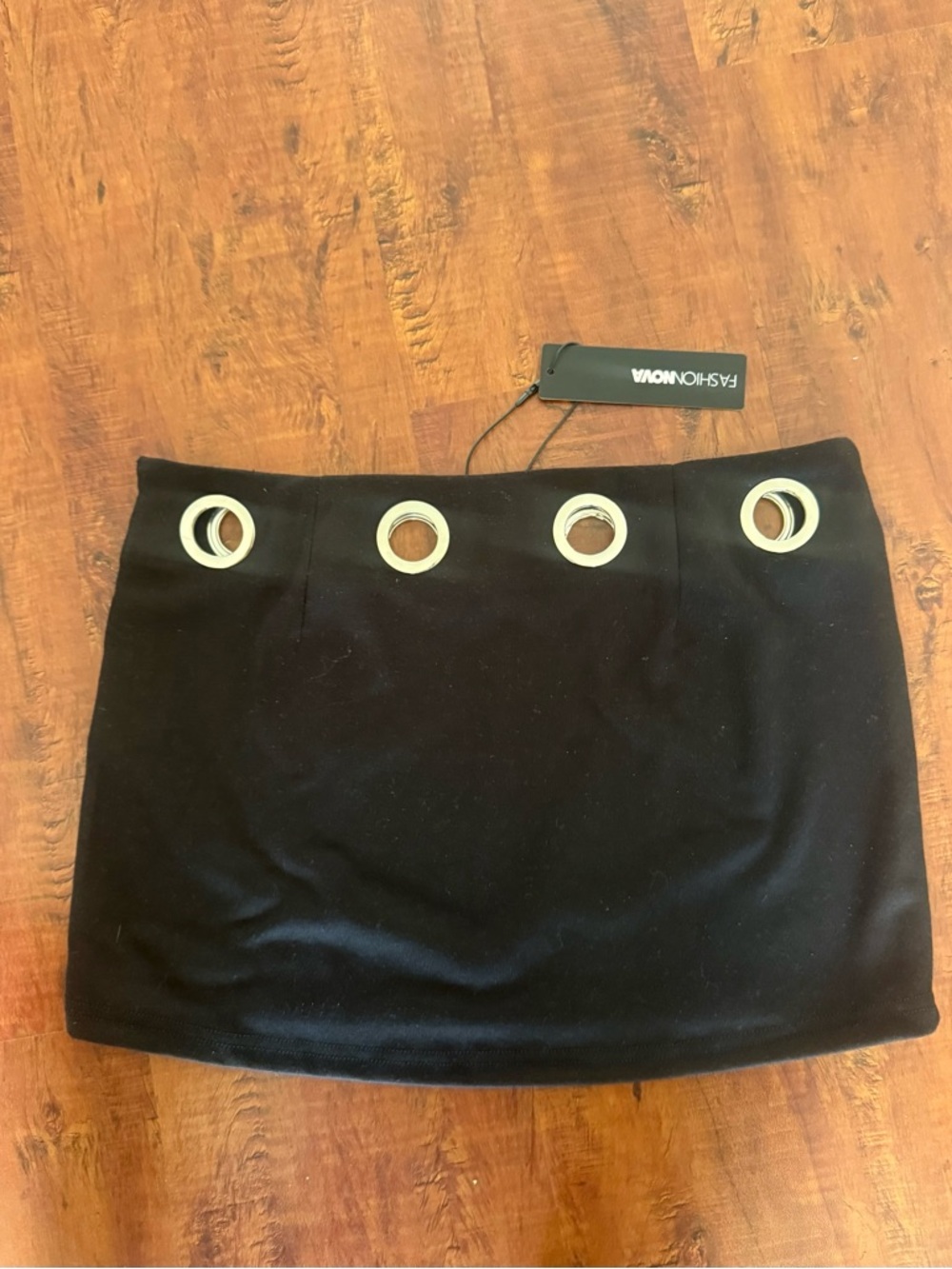 Fashion Nova Black Mini Skirt with Silver Grommet Accents.